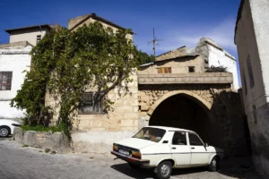 A white car parked in front of a building