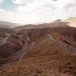 a view of a winding road in the mountains