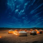 white and brown tent on brown field under blue sky during night time