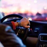 Hand on steering wheel
