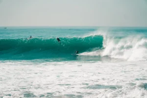 two surfers are riding a wave in the ocean