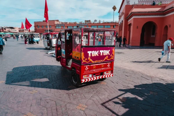 a small red car parked in front of a building