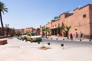 Yellow taxis drive down a sunny street in morocco