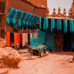assorted-color textiles hanged beside concrete buildings