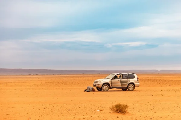 a car parked in the middle of a desert